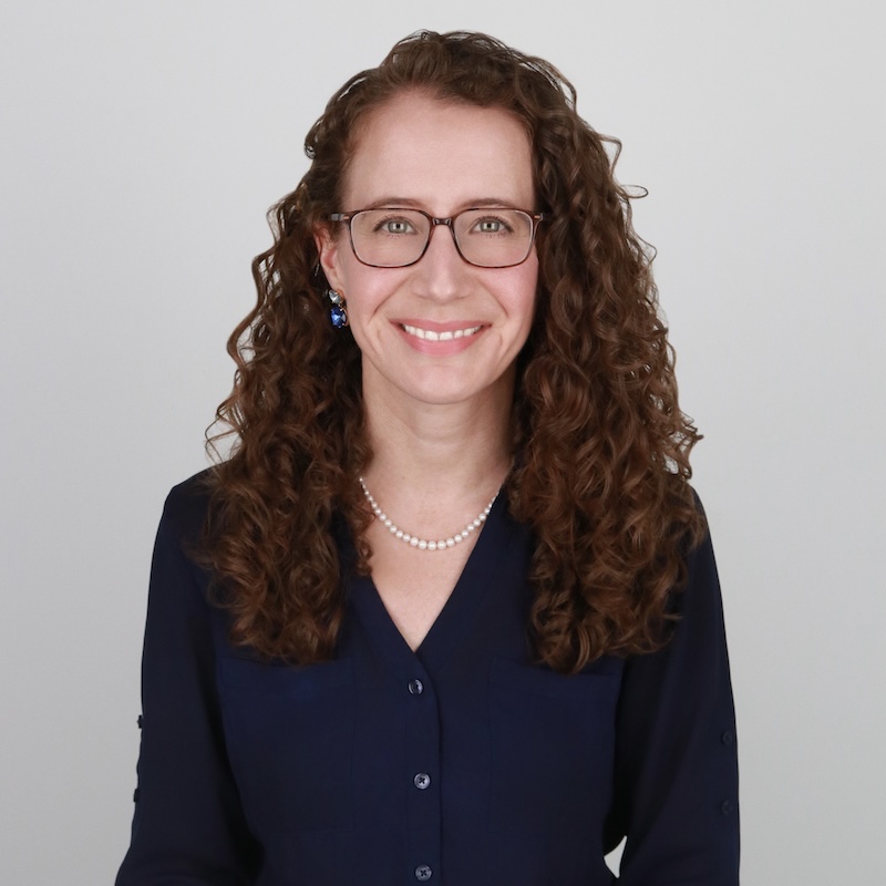 psychotherapist Erica Billings sitting up tall and smiling warmly